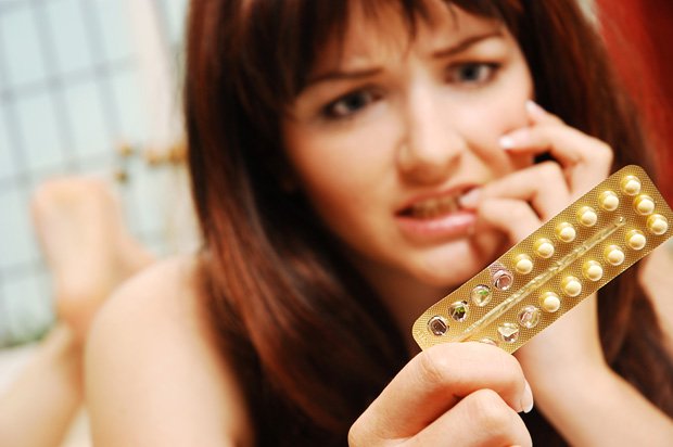 Girl and packet of contraceptive pills