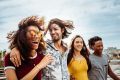 A group of friends is having fun. They are all helping a friend. This is a wide-angle image.