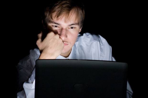 boy on computer in the dark.