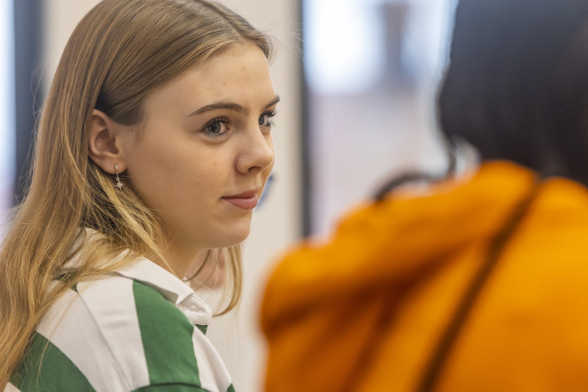 A young woman is thinking about sick pay. This is a close-up image.