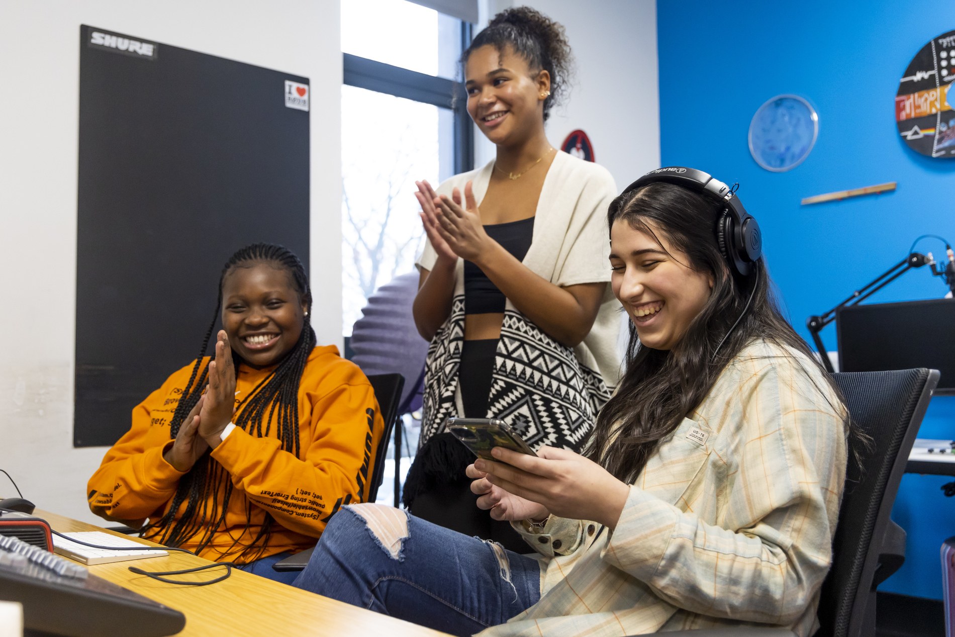 A group of young people are laughing. They are letting go of unrequited love. This is a wide-angle image.