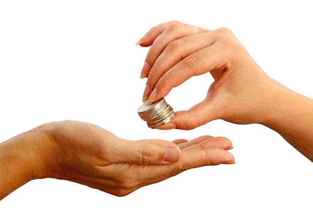 hands passing a small stack of coins