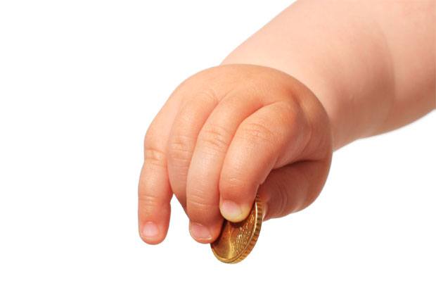 Baby's hand holding a coin