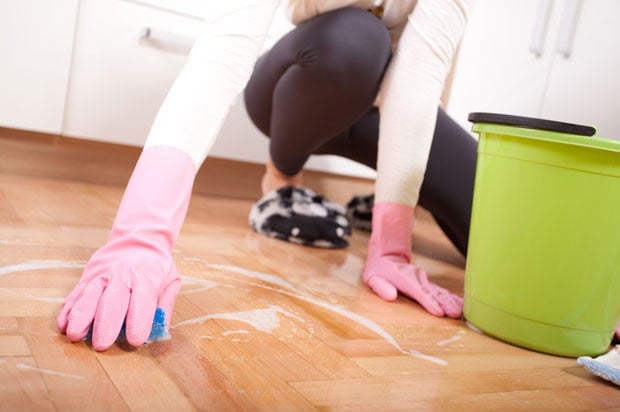 cleaning floor in rubber gloves