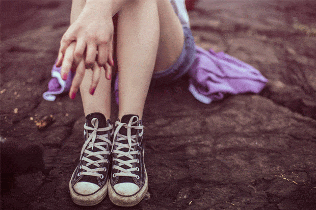girl's legs in converse and hands gripped