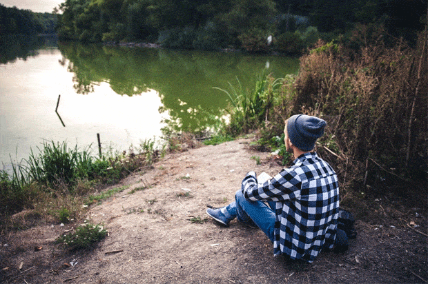guy sitting looking out to lake