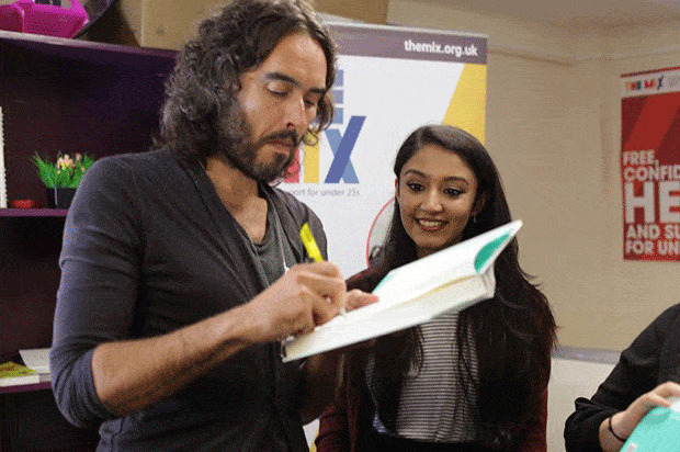 russell brand signs a book for raveena