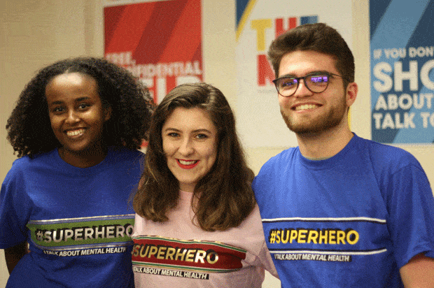 three young people wearing the mental health t-shirts and smiling