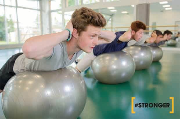 guys on bouncing balls in the gym