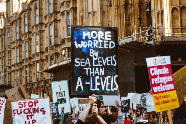 The photo shows a climate strike poster that states: "More worried by sea levels than A-levels"