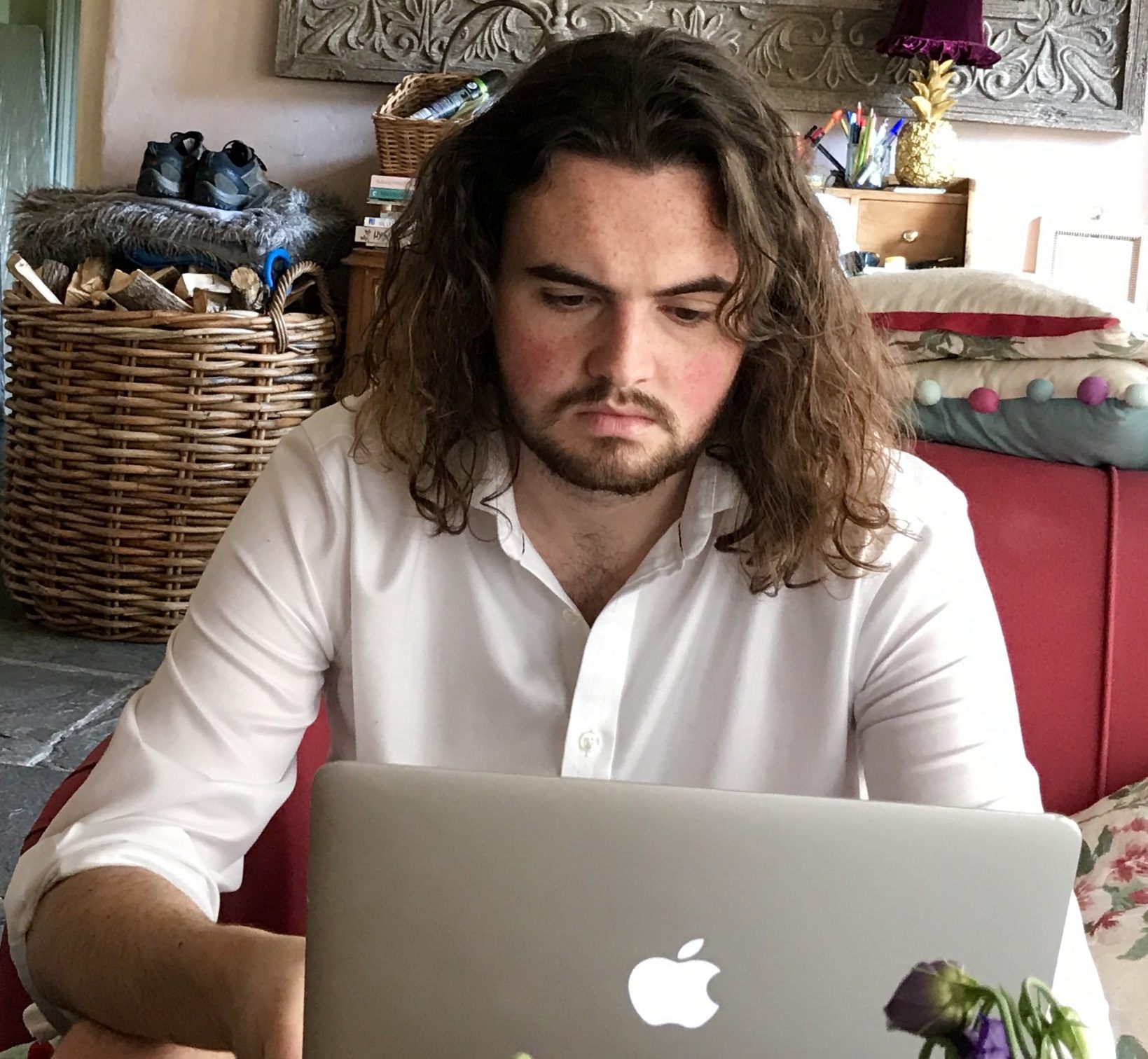 Josh sits working on his laptop