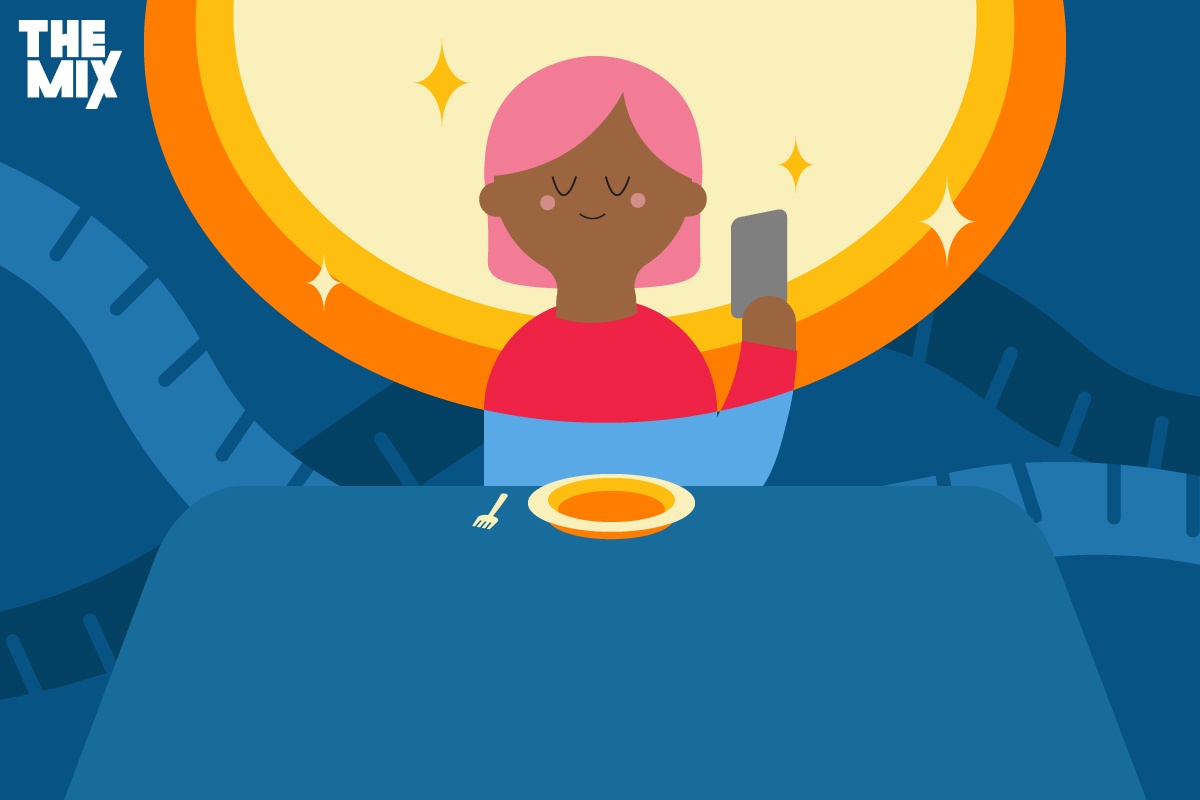 A young person is sitting at a table with an empty plate. They are holding a phone and surrounded by a circle of light to represent the glamourisation of eating disorders