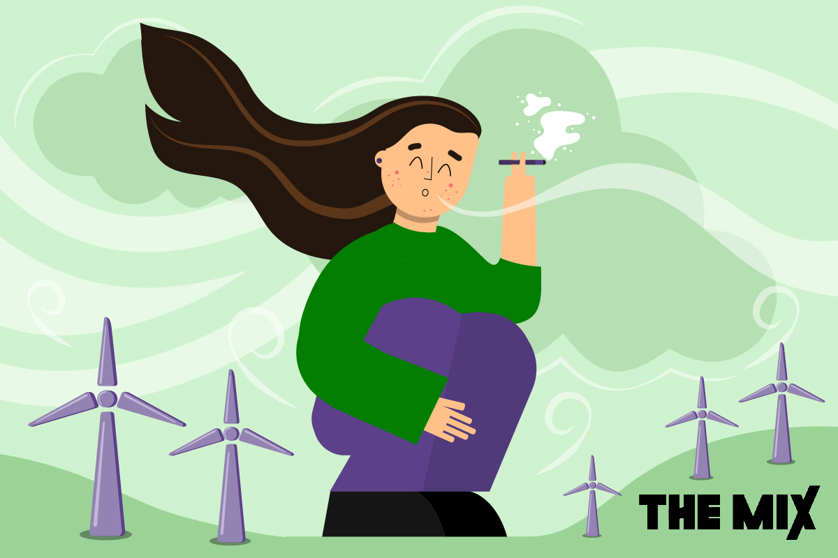 A young person is squatting down smoking a vape. They are wearing purple trousers and a green top and in the background there are wind turbines representing the risks of vaping